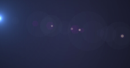 Glowing blue spot of light and purple particles moving against blue background