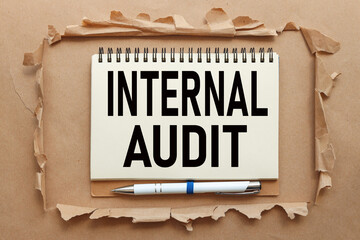 Internal Audit. text on notepad near torn paper