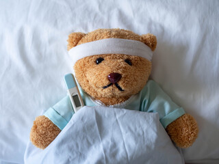 Teddy bear and bandage with thermometer. sick and injury concept - obrazy, fototapety, plakaty