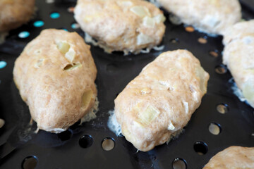 Diet turkey meat cutlets with onions close-up on the black plastic surface of the steamer . egg-free, lactose-free, gluten-free