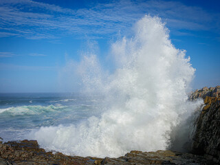 Fototapeta na wymiar Image Number GH5R396066. Spray from a large ocean wave crashing onto rocks at Hermanus. Whale Coast. Overberg. Western Cape. South Africa