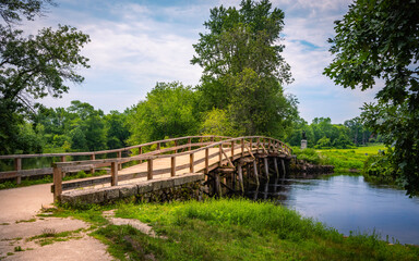 Old North Bridge at Minuteman National Historical Park in Concord, Massachusetts. Tranquil Nature Landscape with Landmark Bridge and Clean River. Peaceful American New England Image.