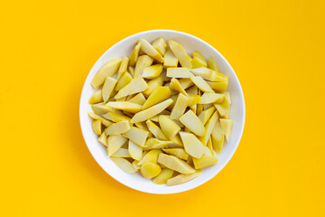 Preserved bamboo shoot in white plate on yellow background.