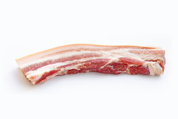 Streaky pork in white plate on yellow background.