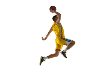 Fototapeta na wymiar Side view. One young man, basketball player with a ball training isolated on white studio background. Advertising concept. Fit Caucasian athlete jumping with ball.
