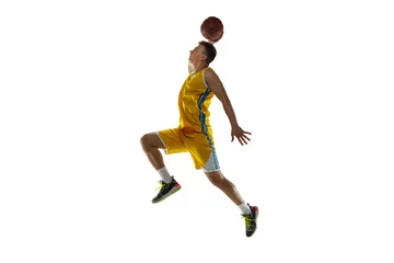Poster Full length portrait of a basketball player with a ball isolated on white studio background. Advertising concept. Fit Caucasian athlete jumping with ball. © master1305