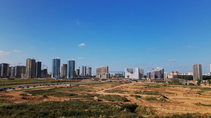 Modern urban development. Construction site with multi-storey buildings under construction. Construction of a new city block. Aerial photography.