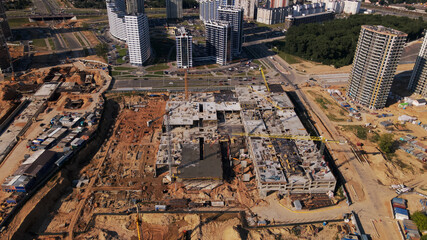 Fototapeta premium Modern urban development. Construction site with multi-storey buildings under construction. Construction of a new city block. Aerial photography.