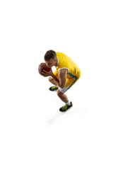 High angle view of young man, basketball player with a ball training isolated on white studio background. Advertising concept. Fit Caucasian athlete jumping with ball.