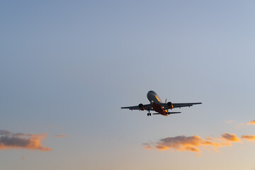 The plane comes in for landing at sunset