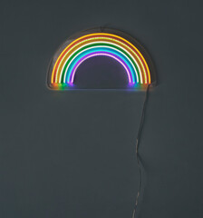 led neon rainbow laying on the white table