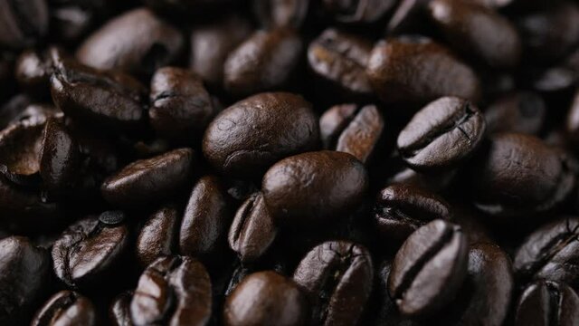 roasted coffee beans close up. rotating video