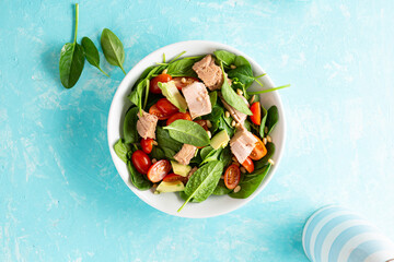 Tuna and spinach salad healthy food blue background