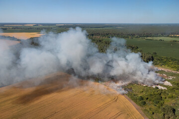 Rubbish dump on wildfire. Concept of environmental pollution