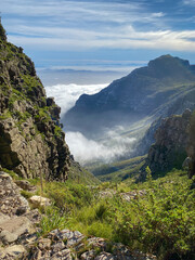 View from top of Platteklip George hiking trail at Table Mountain to upcoming clouds over Cape Town.
