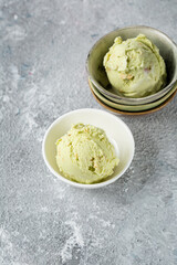 Pistachio ice cream scoops in smallbowl for party food