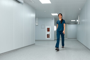 Cheerful doctor woman walks along the corridors of the clinic.