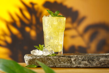 Summer drink with ice and wall with shadows. 