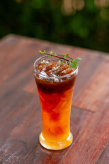 Focus only on the ice point in a glass of iced coffee mixed with orange juice. Looks delicious, smells fresh. Refreshing coffee mixed with fruit juice drinks in a coffee shop.