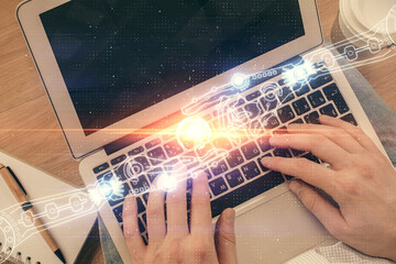 Multi exposure of man's hands typing over computer keyboard and data theme hologram drawing. Top view. Technology concept.