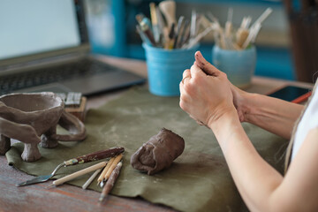artisan pottery tutor in art studio. woman ceramist teaches an online lesson or leads a video...