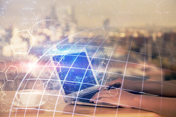 Fototapeta premium Double exposure of woman hands working on computer and world map hologram drawing. International technology business concept.
