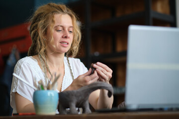 artisan pottery tutor in art studio. woman ceramist teaches an online lesson or leads a video master class on creating ceramic products