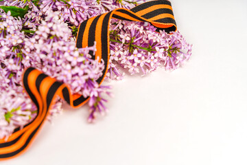 Beautiful floral background with St. George ribbon and lilac. Spring holiday banner with a place for the text