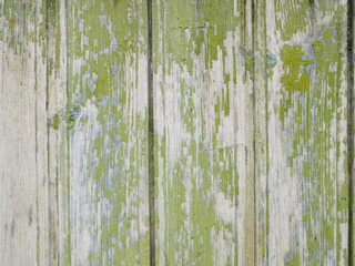The texture of wooden boards. Green paint peels off the board.