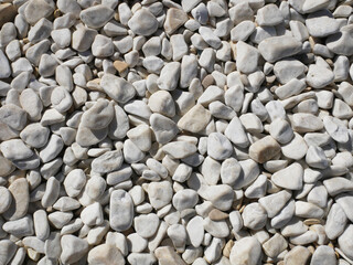 Texture of beach white stones. Pebbles on the beach.