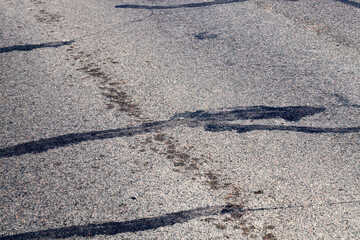 Fototapeta na wymiar part of an asphalt road with damage