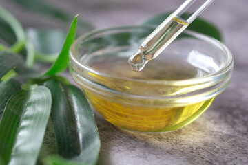 Drop falls from a pipette into a cosmetic bottle