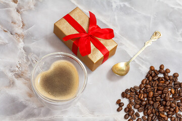 Cup of coffee and roasted coffee beans on kitchen desk.