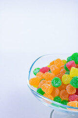 colorful Jelly sugar candies on the glass bowl isolated on white background. Delicios candies story background. Eid mubarak (iyi bayramlar). eid al adha (ramazan bayrami), eid al fitr (kurban bayrami)