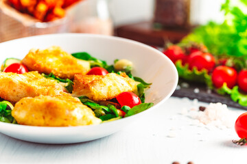 Camembert. Fried camembert cheese with batat fries. Cheese with salad with tomatoes. Fresh food