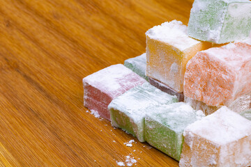 Close up view of the Turkish Delights on the wooden plate. Ramazan bayrami (eid al fitr) and Kurban bayrami (eid al adha) background photo. Turkish delight (lokum). Eid mubarak - iyi bayramlar