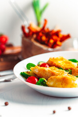Camembert. Fried camembert cheese with batat fries. Cheese with salad with tomatoes. Fresh food
