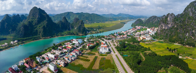 Aerial view: Panoramic view Phong Nha town and Son river in background of mountains in Quang Binh province, Vietnam - 444259763