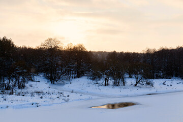 snow-covered river at sunset