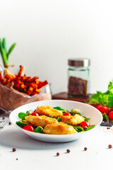 Camembert. Fried camembert cheese with batat fries. Cheese with salad with tomatoes. Fresh food