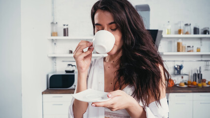 sensual brunette woman enjoying morning coffee with closed eyes
