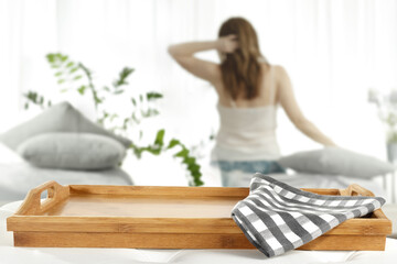 Brown wooden tray of free space for your deocration and slim young woman with window 