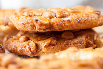 on the surface of a round cookie caramel with peanuts