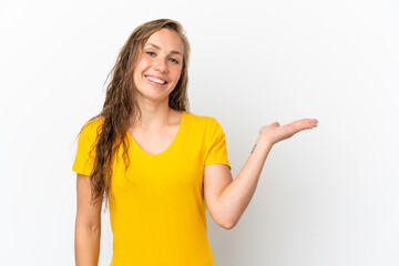 Fototapeta premium Young caucasian woman isolated on white background holding copyspace imaginary on the palm to insert an ad