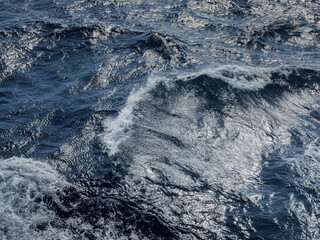 Rough deep turquoise and blue Mediterranean sea with white foam texture background