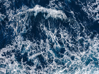 Rough deep turquoise and blue Mediterranean sea with white foam texture background