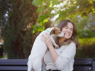 Young woman with her cute Jack Russell Terrier outdoor.