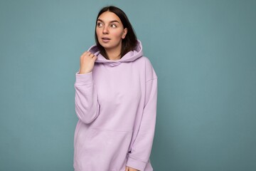 Shot of attractive self-confident sexy young woman wearing casual outfit standing isolated over colourful background with empty space looking to the side