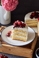 Piece of cake with berries. Side view, peonies.