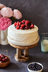 Cake with berries. Side view, peonies.